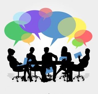 people sitting around a table discussion ideas